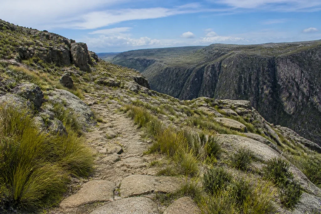 Rocky walking trail in open highland terrain at Quebrada del Condorito National Park.