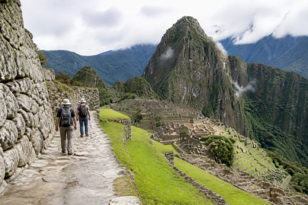 Visitors on a stone route at the Machu Picchu archaeological site