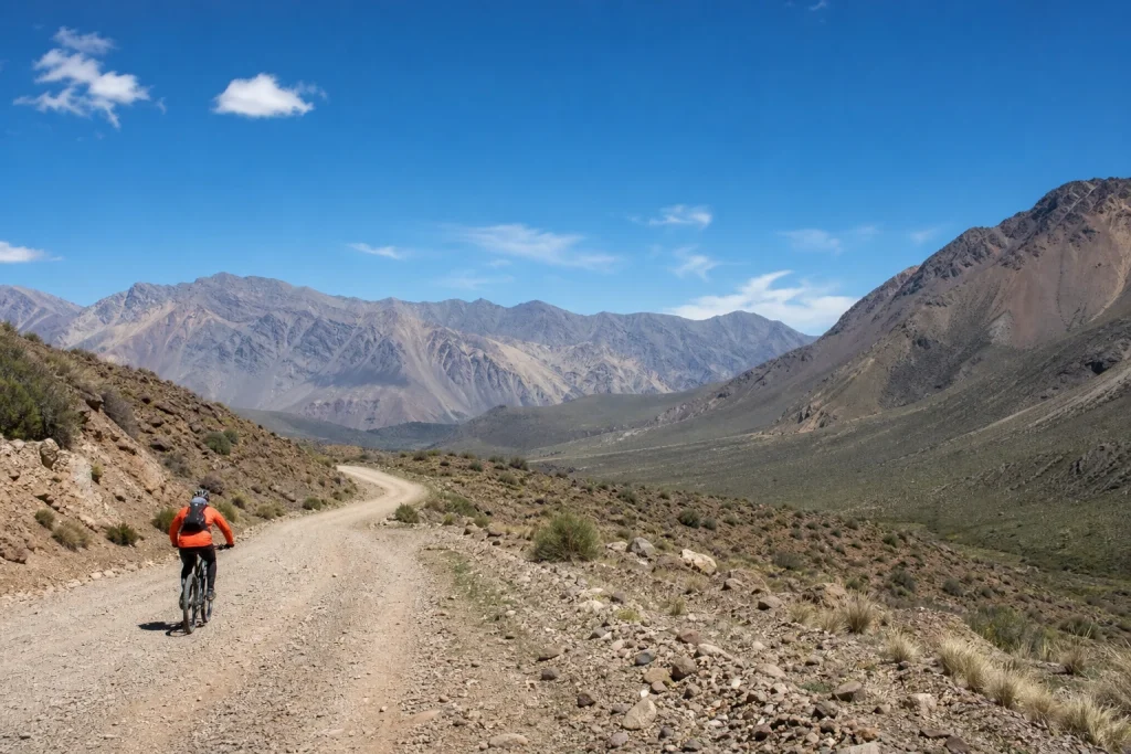Mountain biker on an unpaved road in the Andean foothills near Mendoza, Argentina
