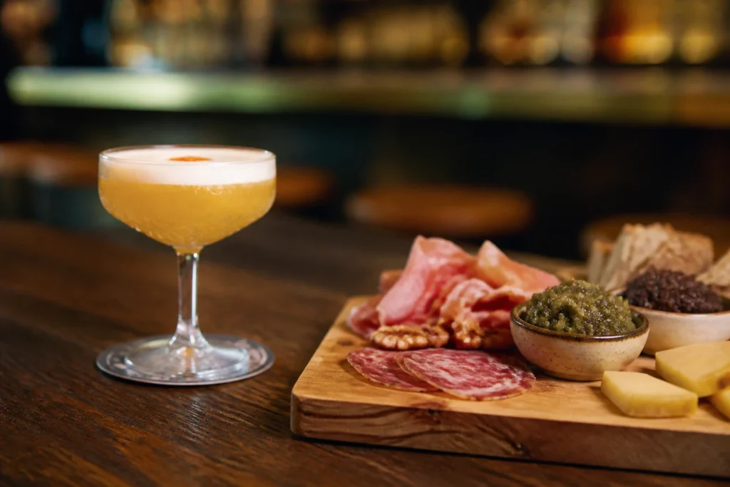 Cocktail and charcuterie board at La Feliz Bar Charcuterie in Mendoza