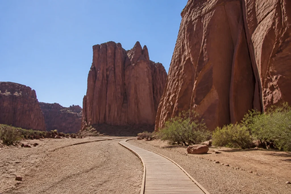 Red sandstone walls and visitor walkway in Talampaya Canyon