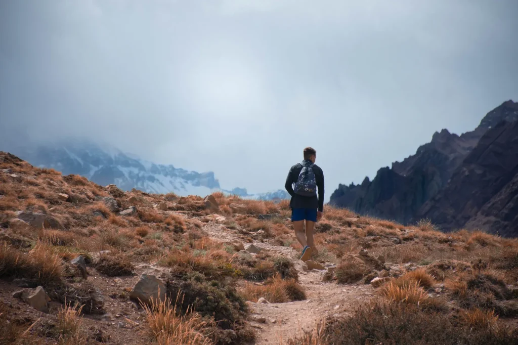 Hiker wearing adaptable layers on an Andes trail in Argentina