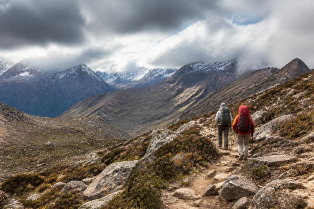 Equipped hikers on a rugged mountain trail in Argentine Patagonia.